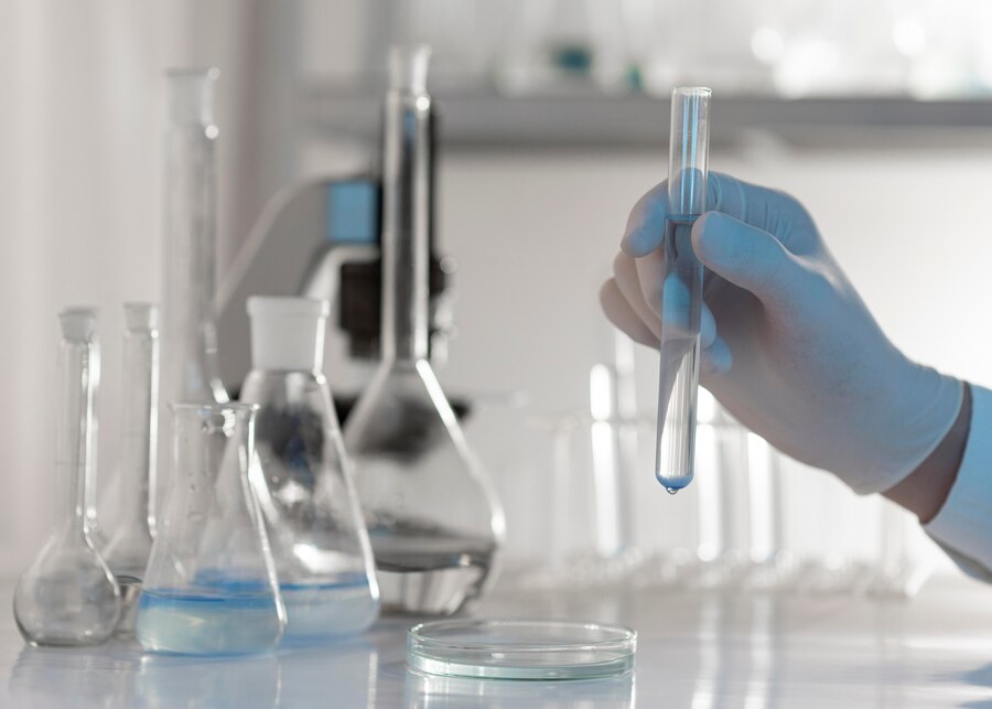 close-up-hand-holding-tube-with-solution_23-2148794414