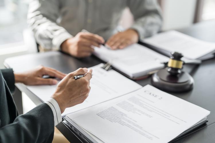 Lawyer Legal counsel presents to the client a signed contract wi